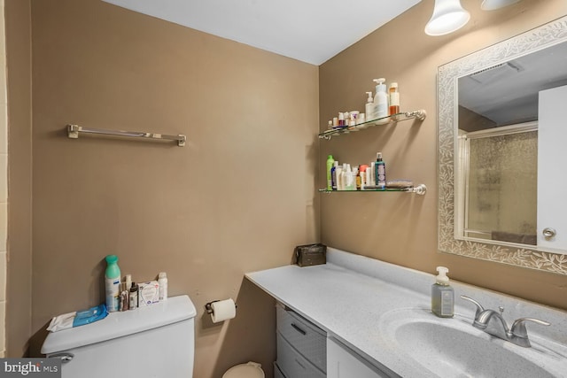 bathroom featuring visible vents, a shower with shower door, vanity, and toilet