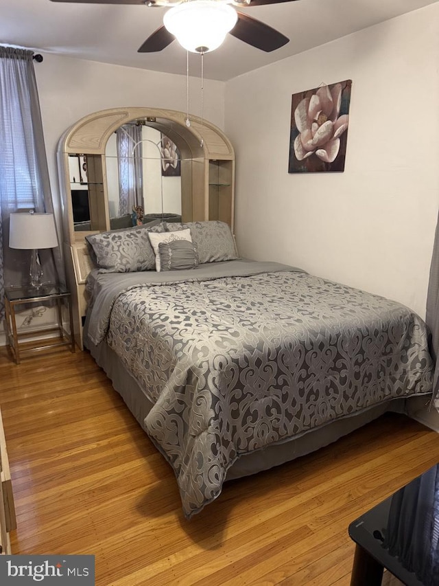 bedroom featuring light wood-type flooring and ceiling fan