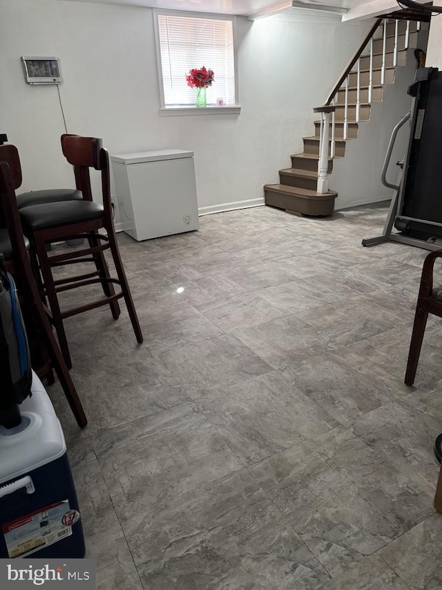 interior space with stairway and fridge