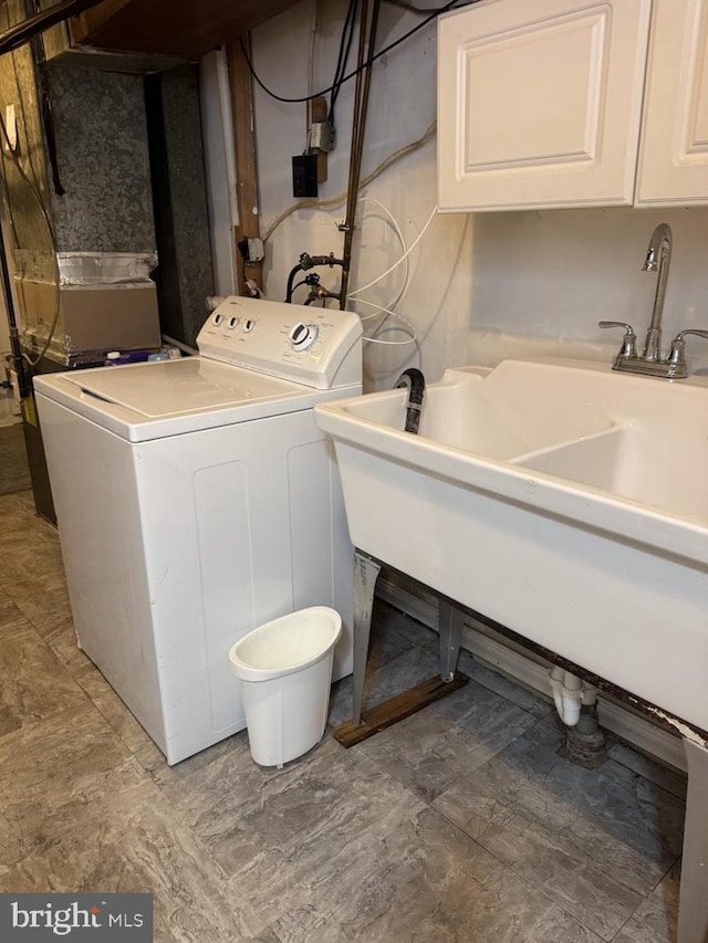 laundry room featuring washer / clothes dryer and cabinet space