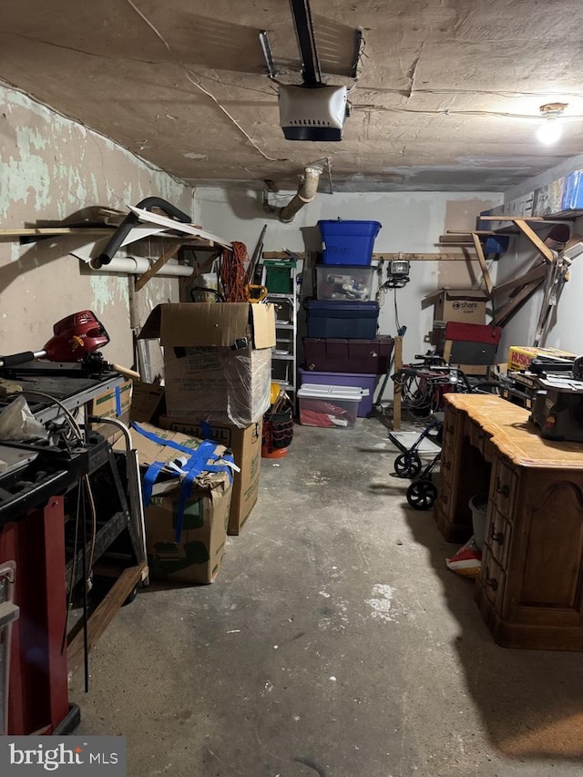 garage with a workshop area and a garage door opener