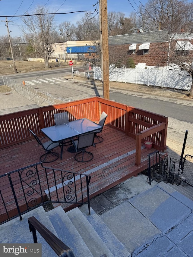 wooden deck featuring outdoor dining area and fence