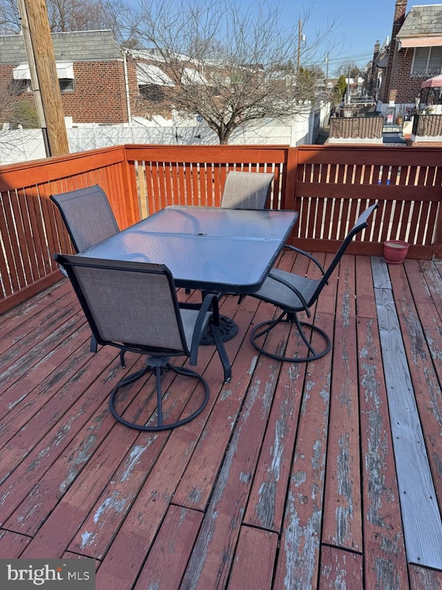 snow covered deck with outdoor dining area