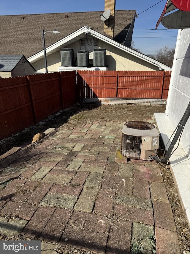 view of patio featuring central AC and a fenced backyard