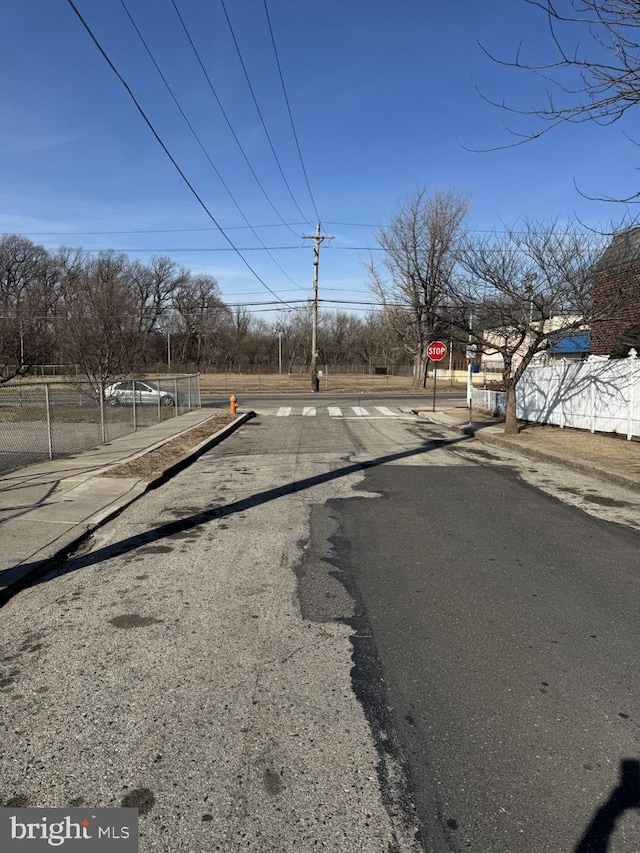 view of road with curbs and traffic signs