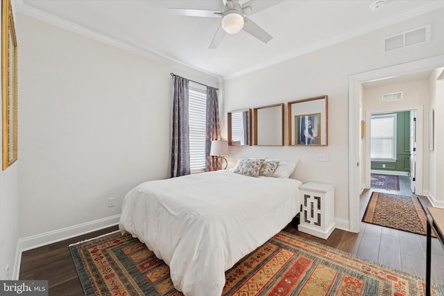 bedroom featuring visible vents, multiple windows, and wood finished floors