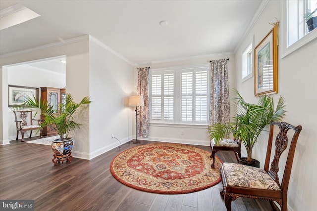 sitting room with crown molding, baseboards, and wood finished floors