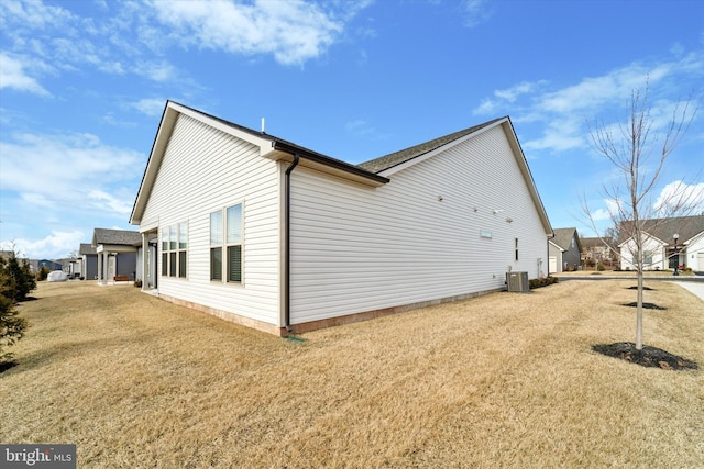 view of home's exterior featuring central AC unit and a lawn