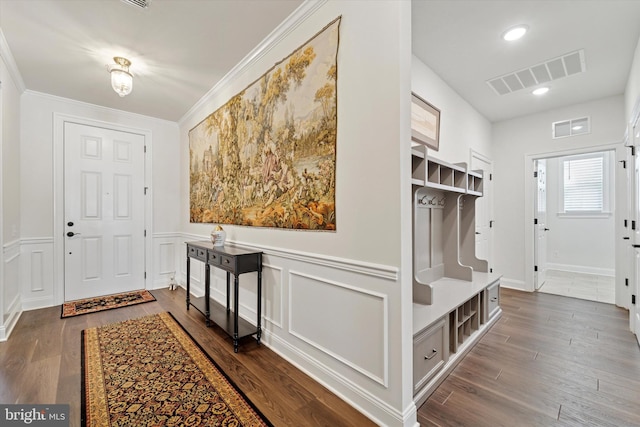 mudroom featuring ornamental molding, dark wood finished floors, and visible vents