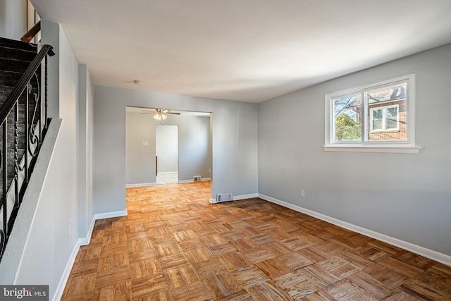 spare room with visible vents, stairs, and baseboards