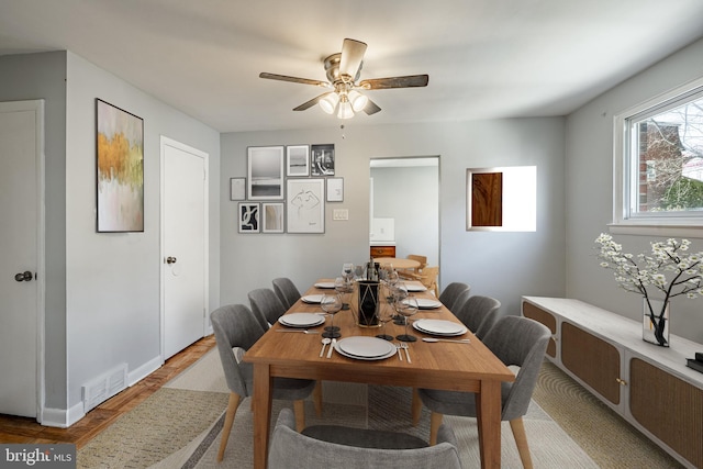 dining area with visible vents and ceiling fan