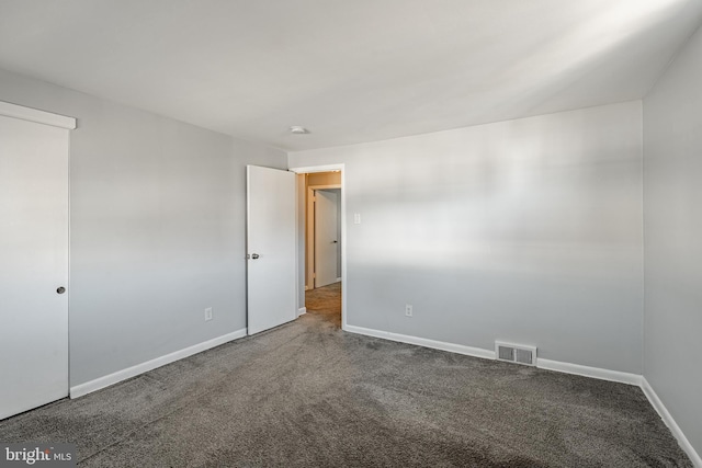 unfurnished bedroom featuring visible vents, carpet floors, and baseboards