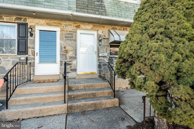 doorway to property with stone siding