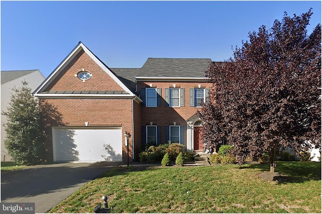 view of front facade with a garage, aphalt driveway, a front lawn, and brick siding