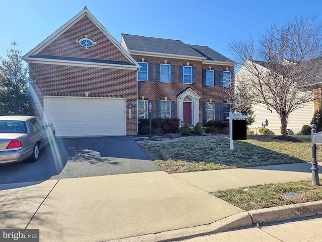 view of front of home featuring aphalt driveway and brick siding