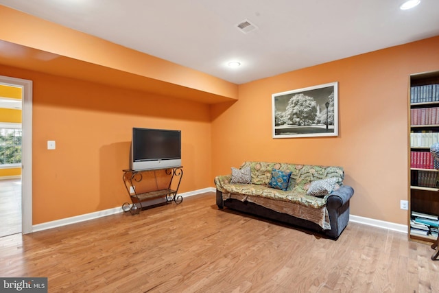 sitting room featuring baseboards, visible vents, and wood finished floors