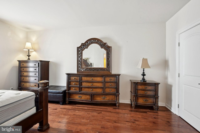 bedroom featuring dark wood-type flooring and baseboards