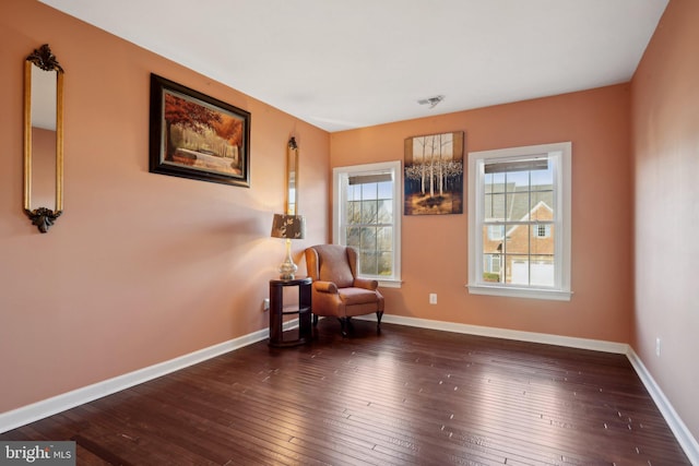 sitting room with visible vents, baseboards, and hardwood / wood-style flooring