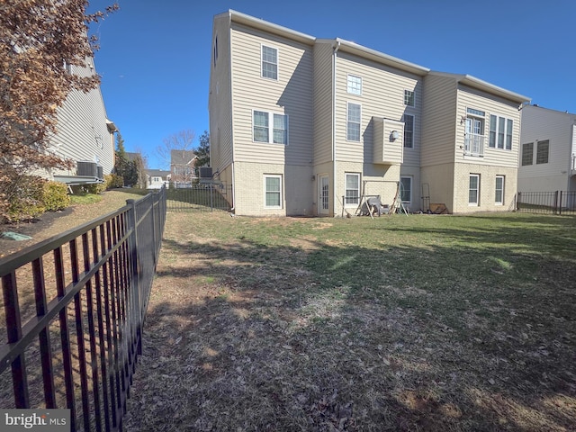 exterior space with a fenced backyard, a residential view, a lawn, and brick siding