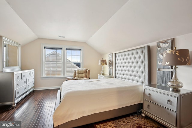 bedroom with lofted ceiling, dark wood-type flooring, visible vents, and baseboards