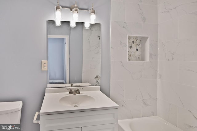bathroom featuring toilet, vanity, and shower / bathing tub combination