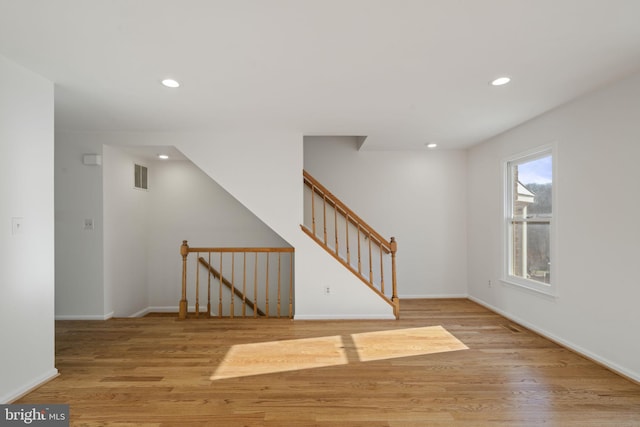 interior space featuring visible vents, recessed lighting, baseboards, and wood finished floors