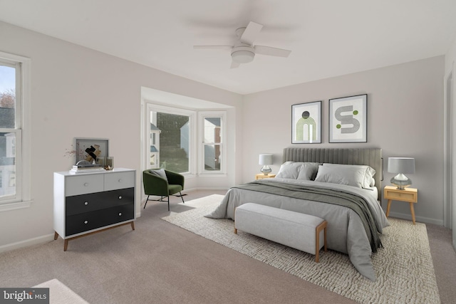 carpeted bedroom with baseboards and a ceiling fan