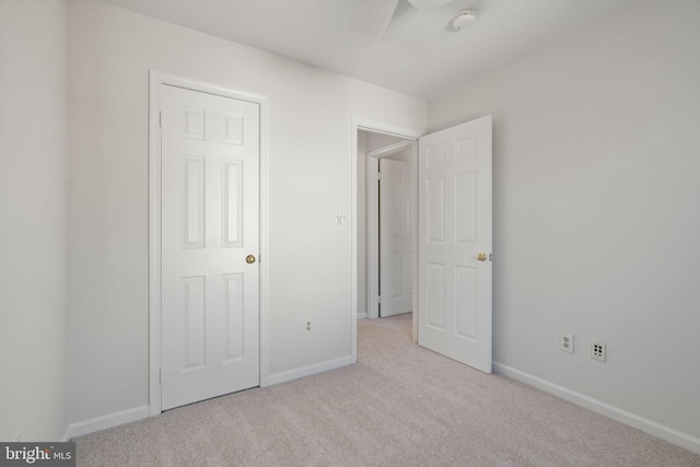 unfurnished bedroom with baseboards and carpet