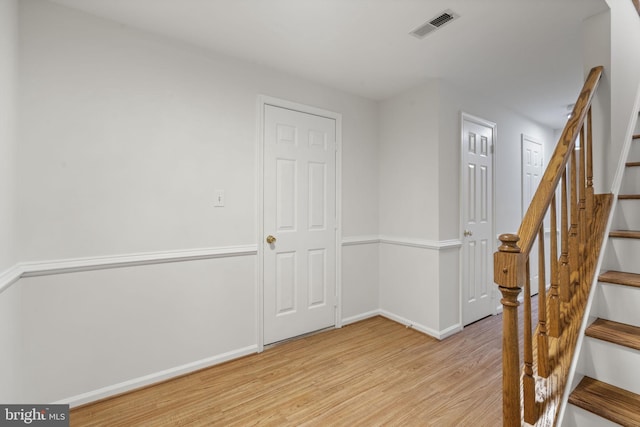 interior space featuring visible vents, baseboards, and wood finished floors