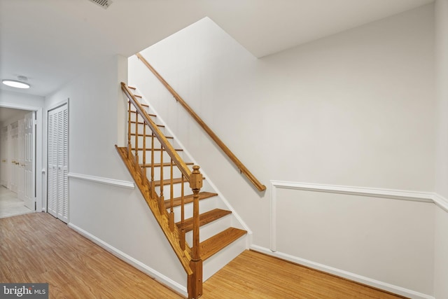 stairway with baseboards and wood finished floors