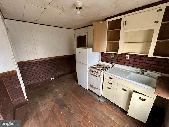 kitchen featuring white appliances, dark wood-type flooring, a sink, light countertops, and open shelves