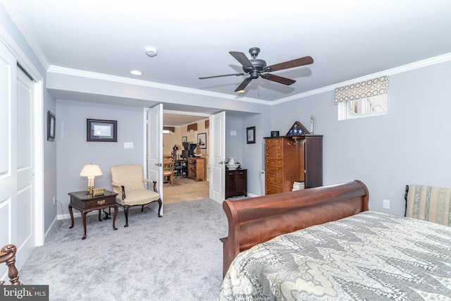 carpeted bedroom with a ceiling fan, baseboards, and crown molding