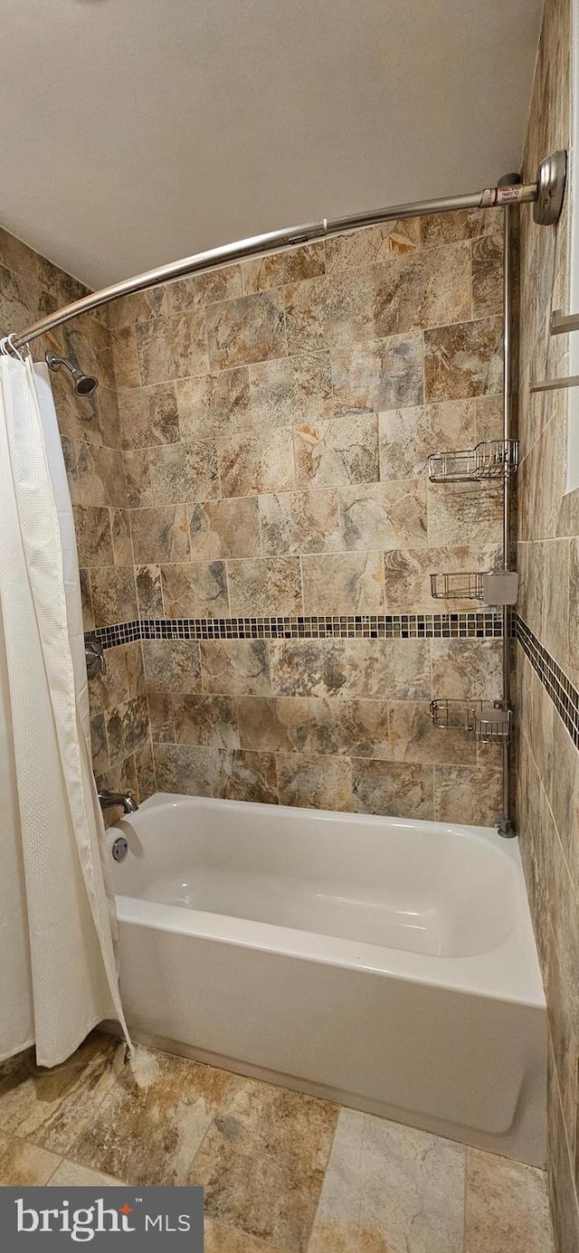 bathroom with shower / bath combo with shower curtain