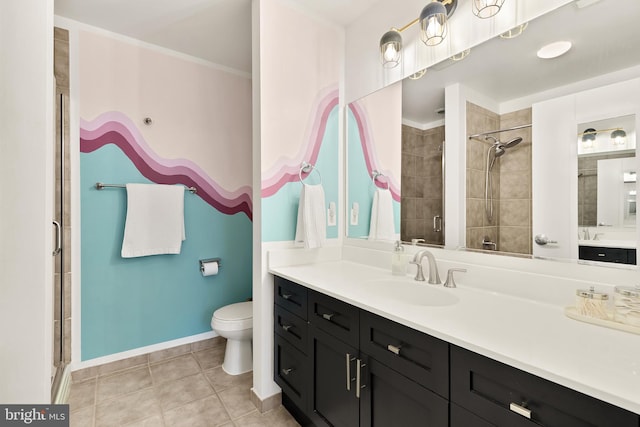 bathroom with tile patterned flooring, a shower stall, baseboards, toilet, and vanity