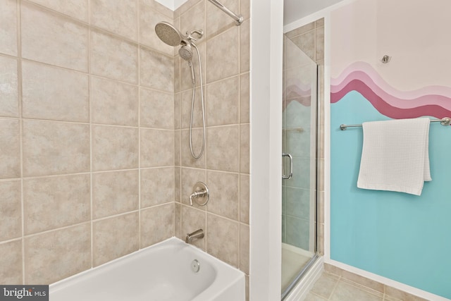 full bath with tile patterned flooring, enclosed tub / shower combo, and baseboards