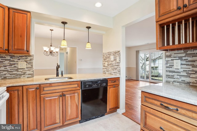 kitchen with decorative backsplash, black dishwasher, brown cabinets, and a sink