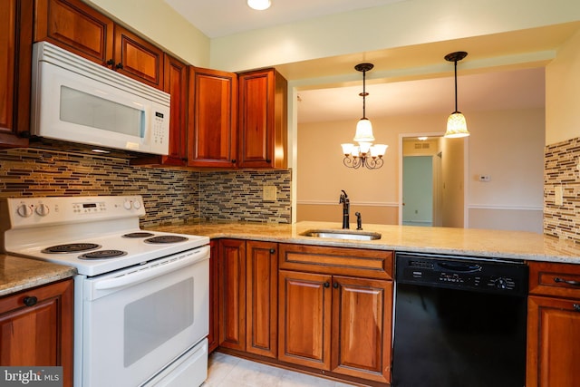 kitchen with white appliances, light stone countertops, a sink, hanging light fixtures, and backsplash