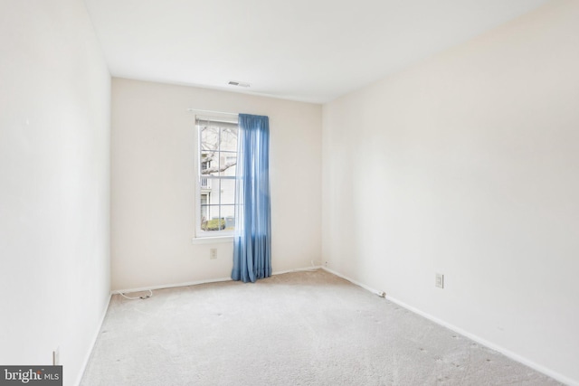 unfurnished room featuring visible vents, baseboards, and carpet flooring