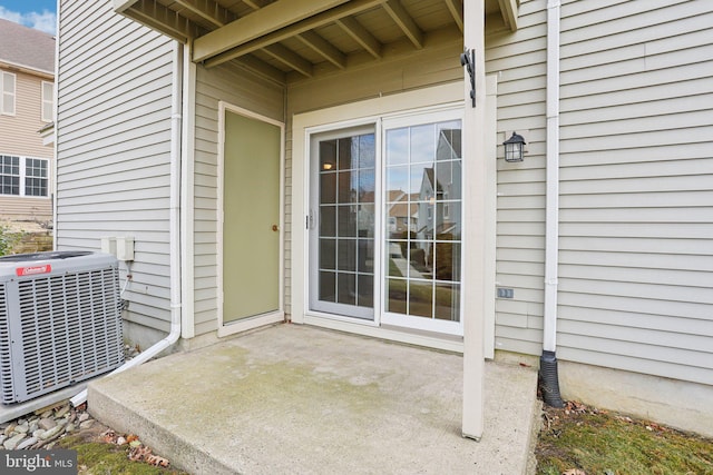 doorway to property featuring a patio area and central AC unit