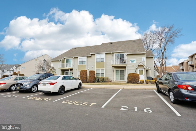 uncovered parking lot featuring a residential view