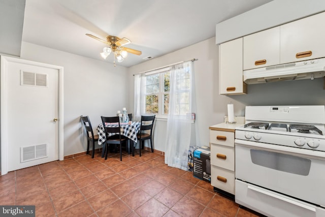 kitchen with white gas range, visible vents, light countertops, white cabinetry, and under cabinet range hood