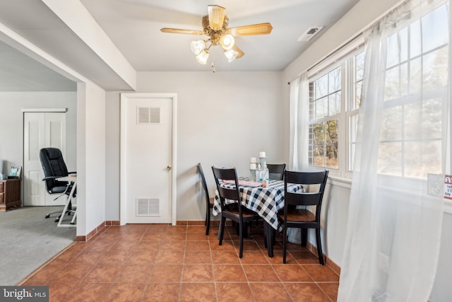 dining room featuring ceiling fan, light tile patterned flooring, visible vents, and baseboards