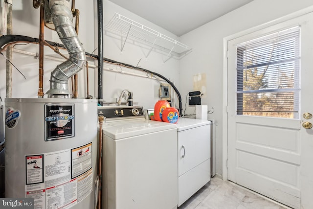 washroom with washing machine and dryer, gas water heater, marble finish floor, and laundry area