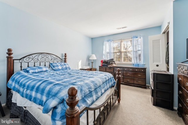 bedroom with visible vents and light colored carpet