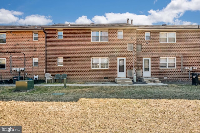 exterior space with a yard, brick siding, and central air condition unit