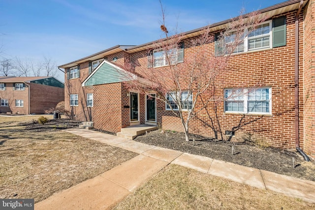 back of property featuring brick siding