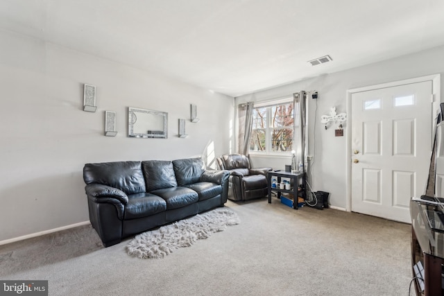 living room with carpet floors, baseboards, and visible vents