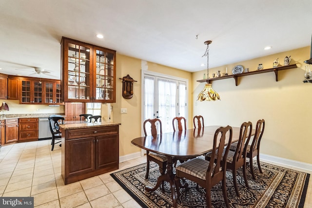 dining space with recessed lighting, built in desk, baseboards, and light tile patterned floors