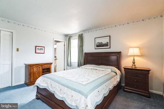 bedroom with baseboards and dark carpet