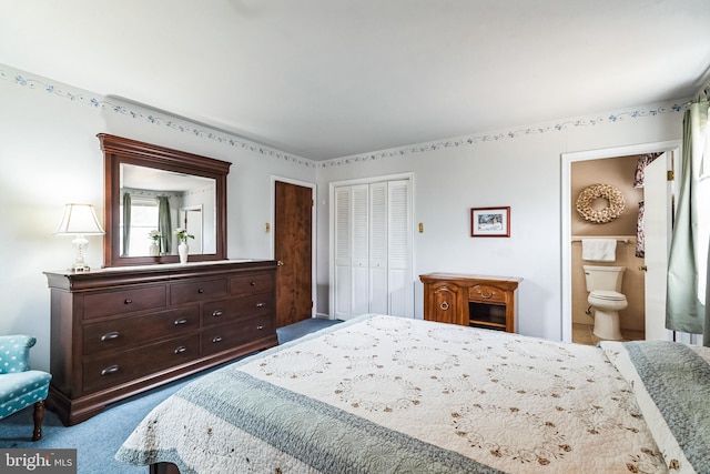 bedroom with carpet floors, a closet, and ensuite bath